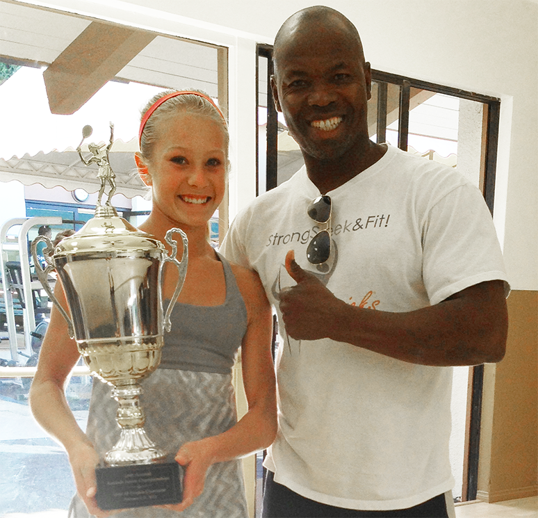 MisterG with an athlete holding a trophy